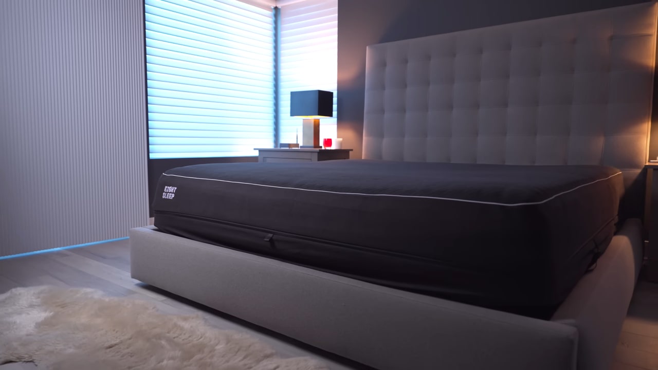 Modern bedroom with an Eight Sleep smart mattress on a minimalist bed frame, ambient lighting, and sleek furniture
