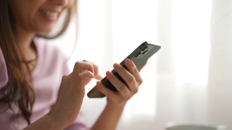 A person cleans up their mobile device after returning home from a trip