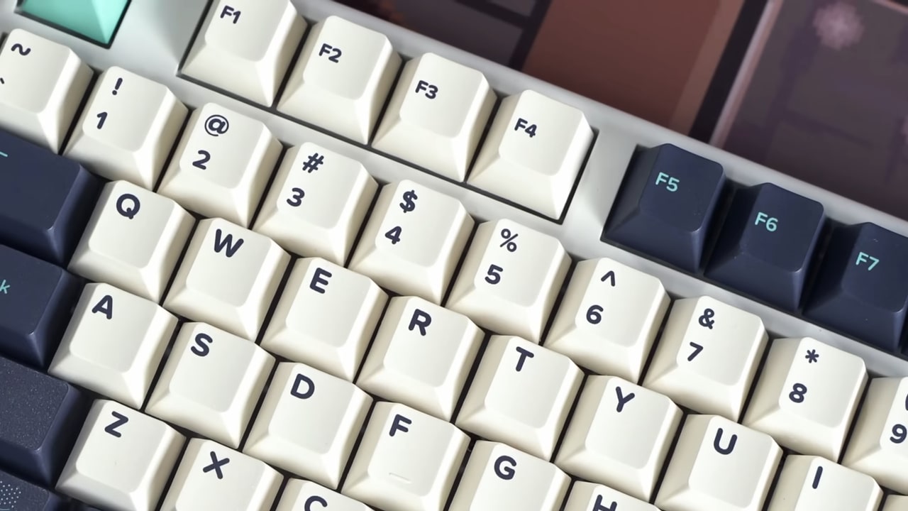 Close-up of a clean mechanical keyboard with cream and dark-colored keycaps