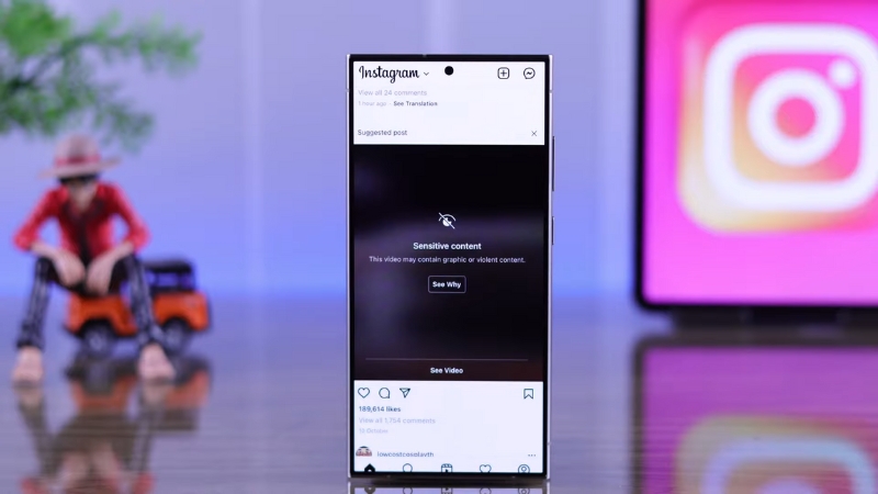 A smartphone screen displays a hidden Instagram post labeled as sensitive content