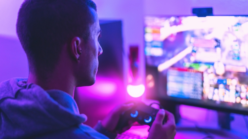 Person watching esports on screen, showing top streaming platforms