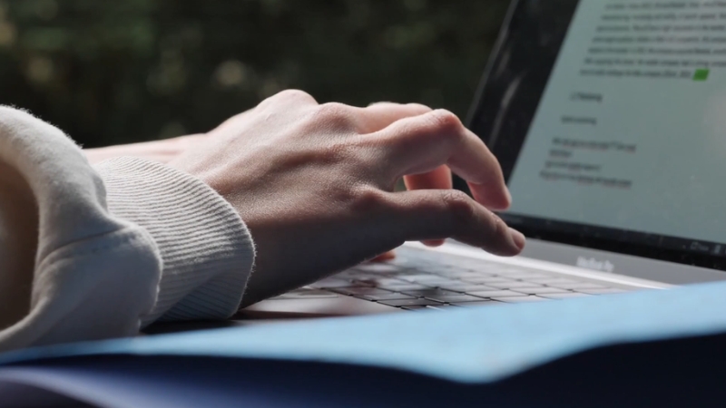 A close-up of someone typing on a laptop, focused on using real data to prioritize IT priorities effectively