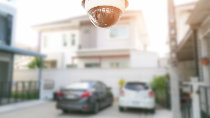 A security camera overlooking a driveway helps your home feel safer by monitoring activity around the property